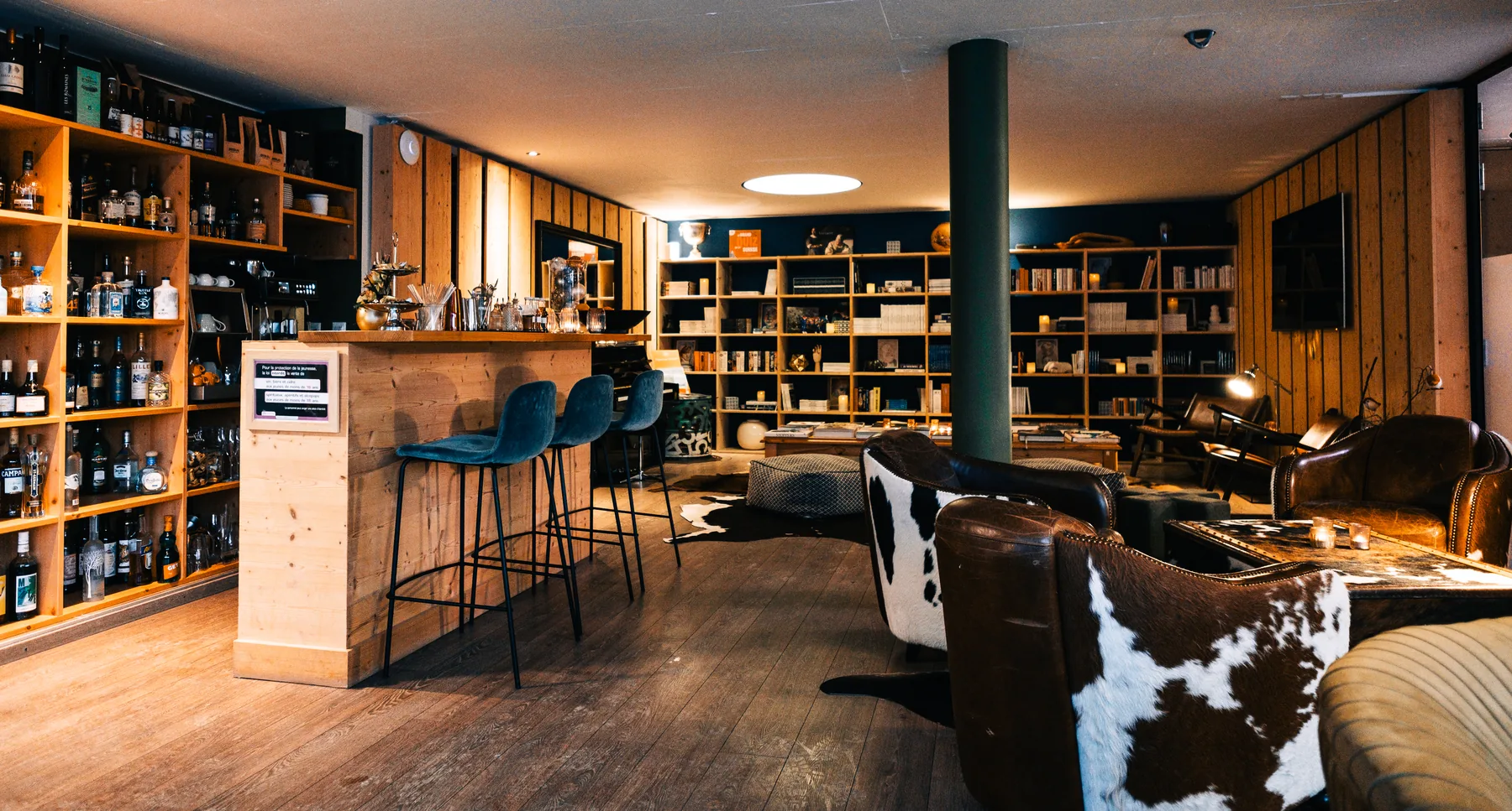The Café Littéraire in the evening, the lamps lit over the armchairs