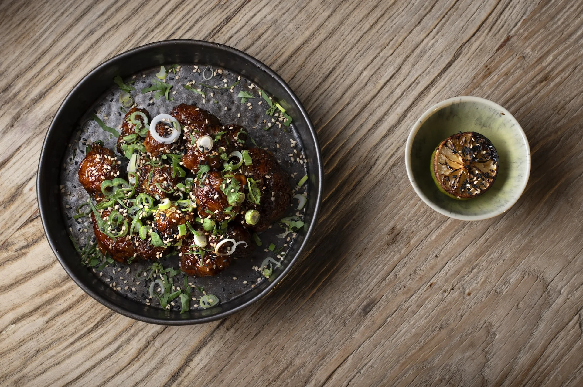 A glazed signature dish at Saskia's on the wooden table