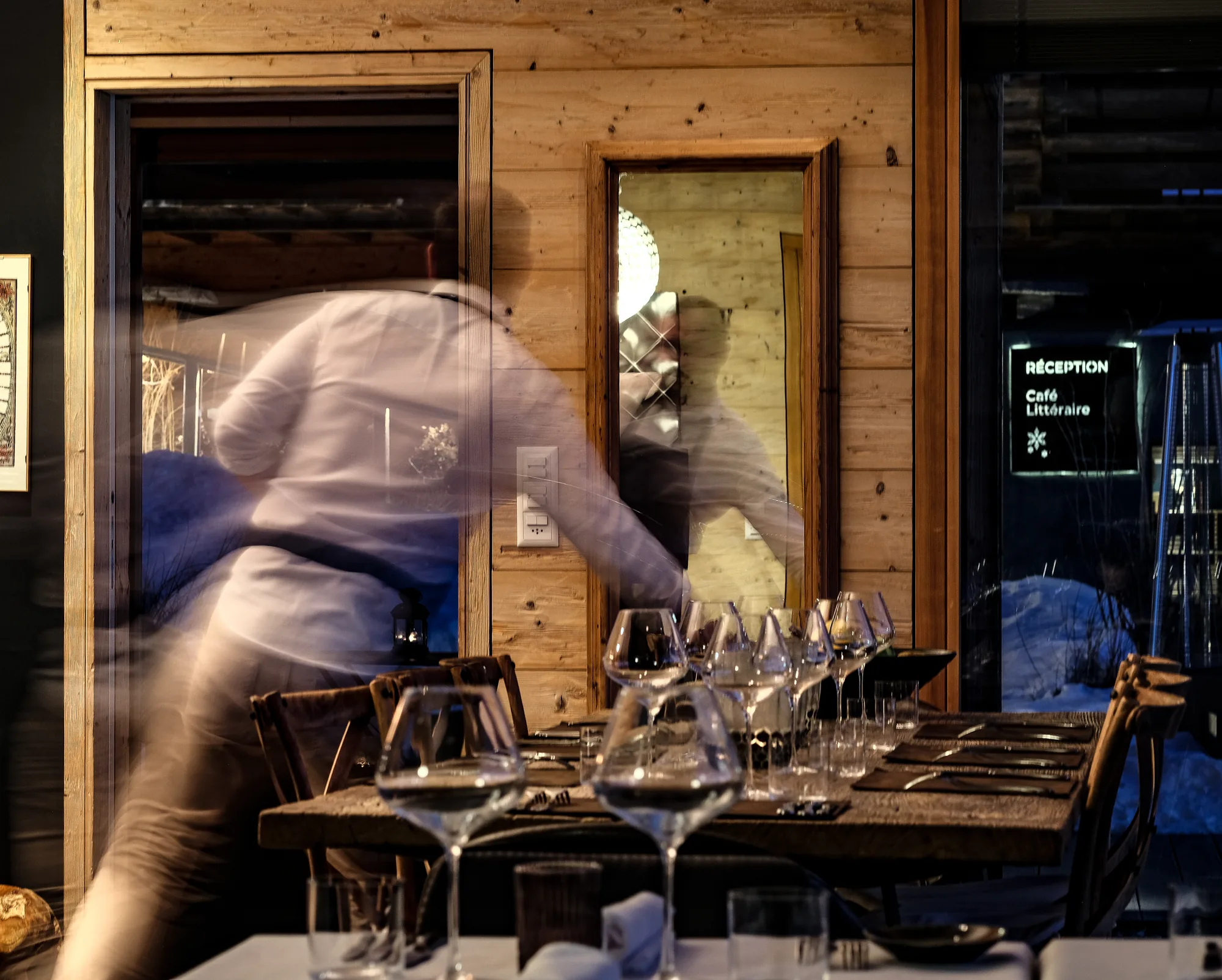 An evening at Saskia's: a set table with wine glasses in the chalet dining room